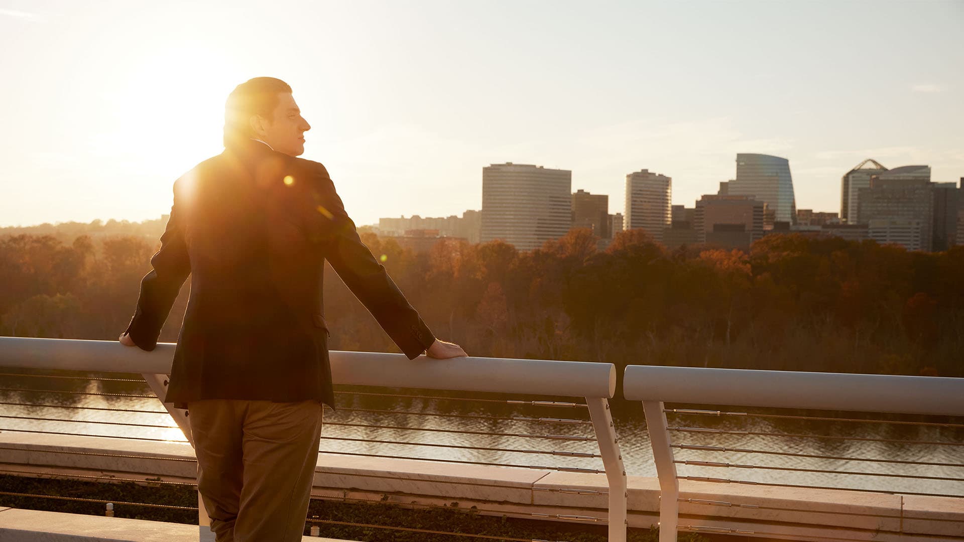 A man gazes across a river longingly