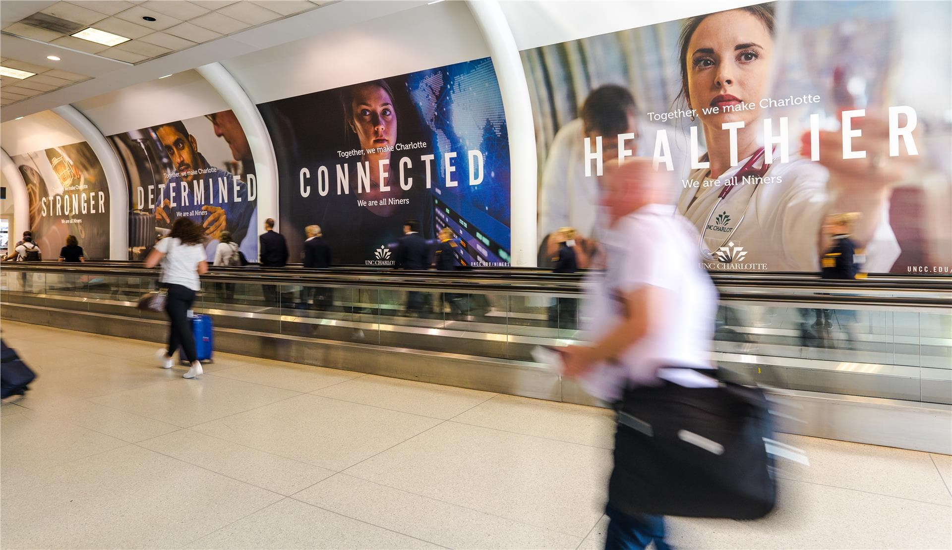 A display of several out of home placements of our work in Charlotte International Airport
