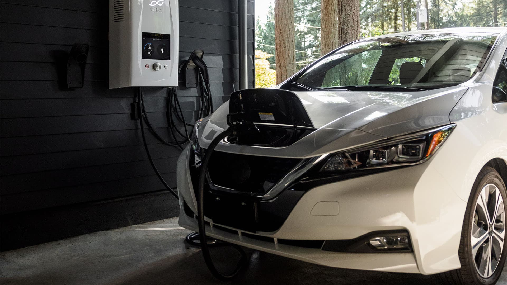 An electric vehicle being charged in a garage
