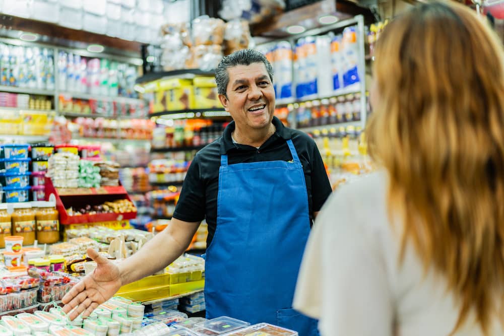 Shopkeeper smiling in the store