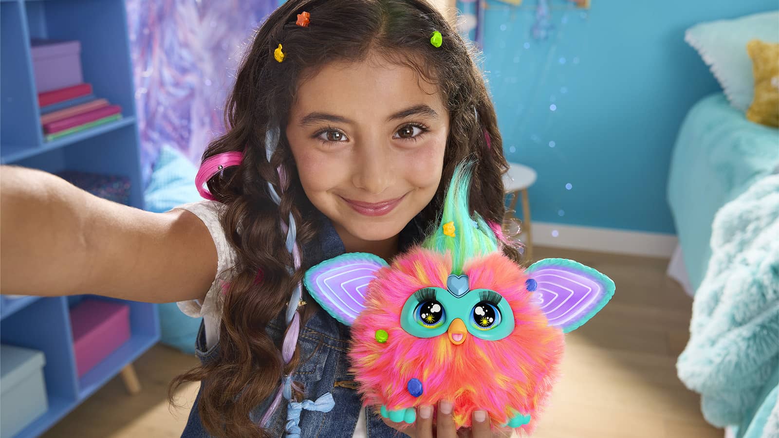 A girl holds a Furby