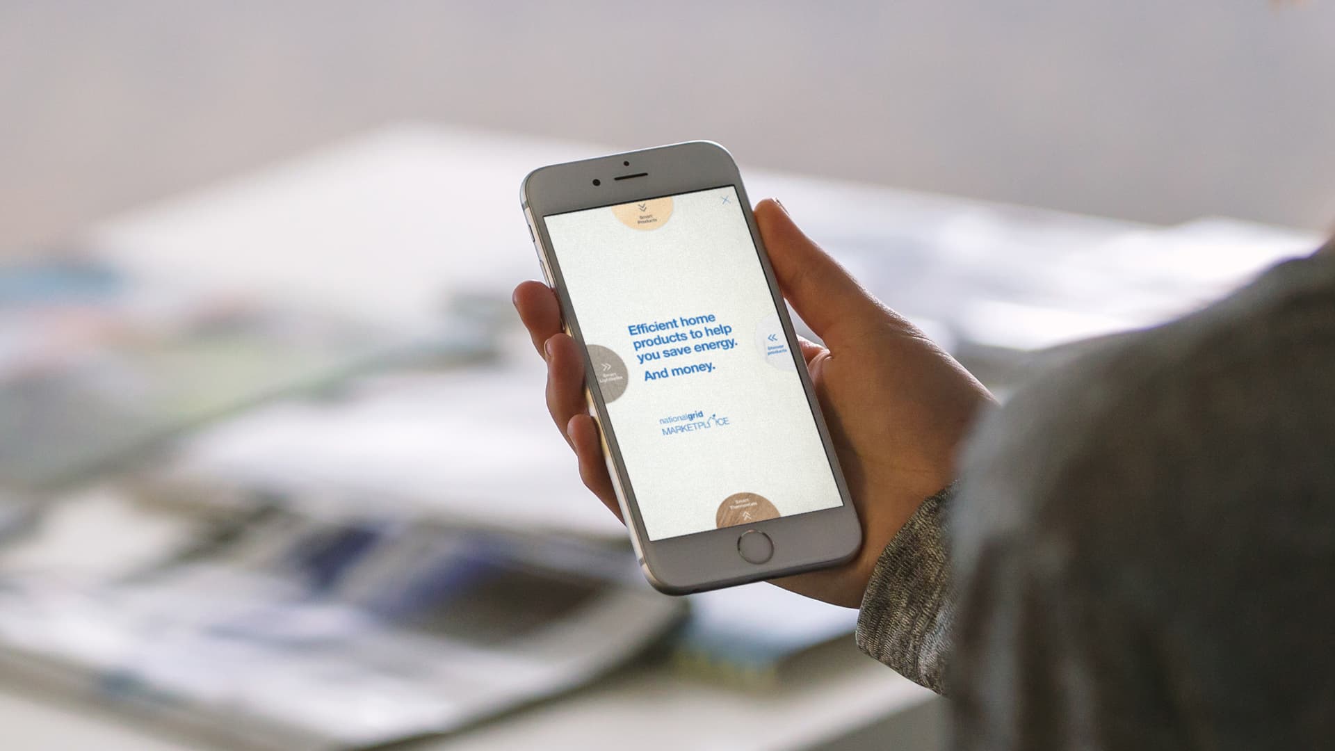 A hand holding a phone displaying a National Grid rich media unit ad