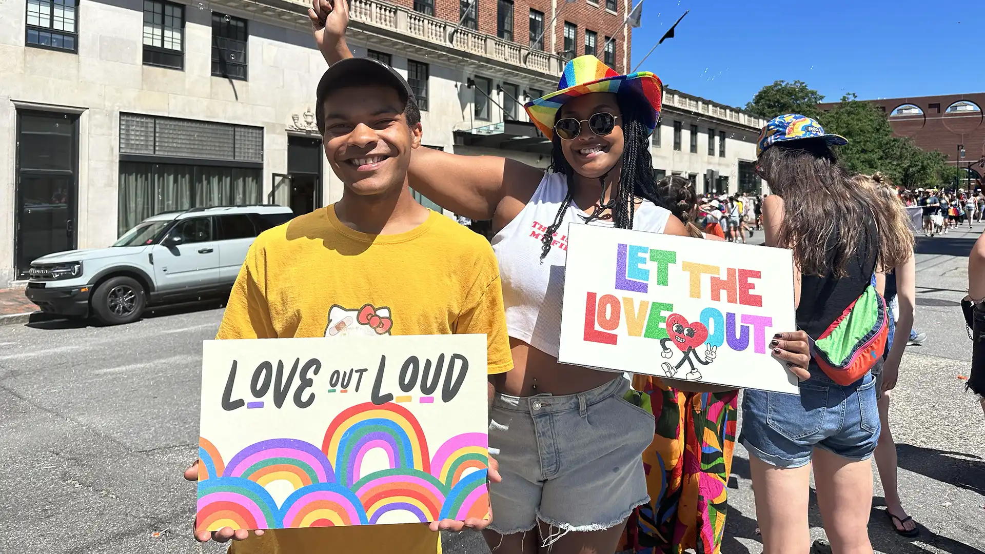 Pride parade goers with posters