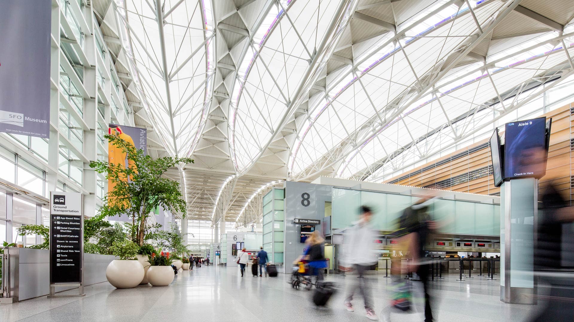 People walking through the airport, their blurred forms conveying a sense of motion