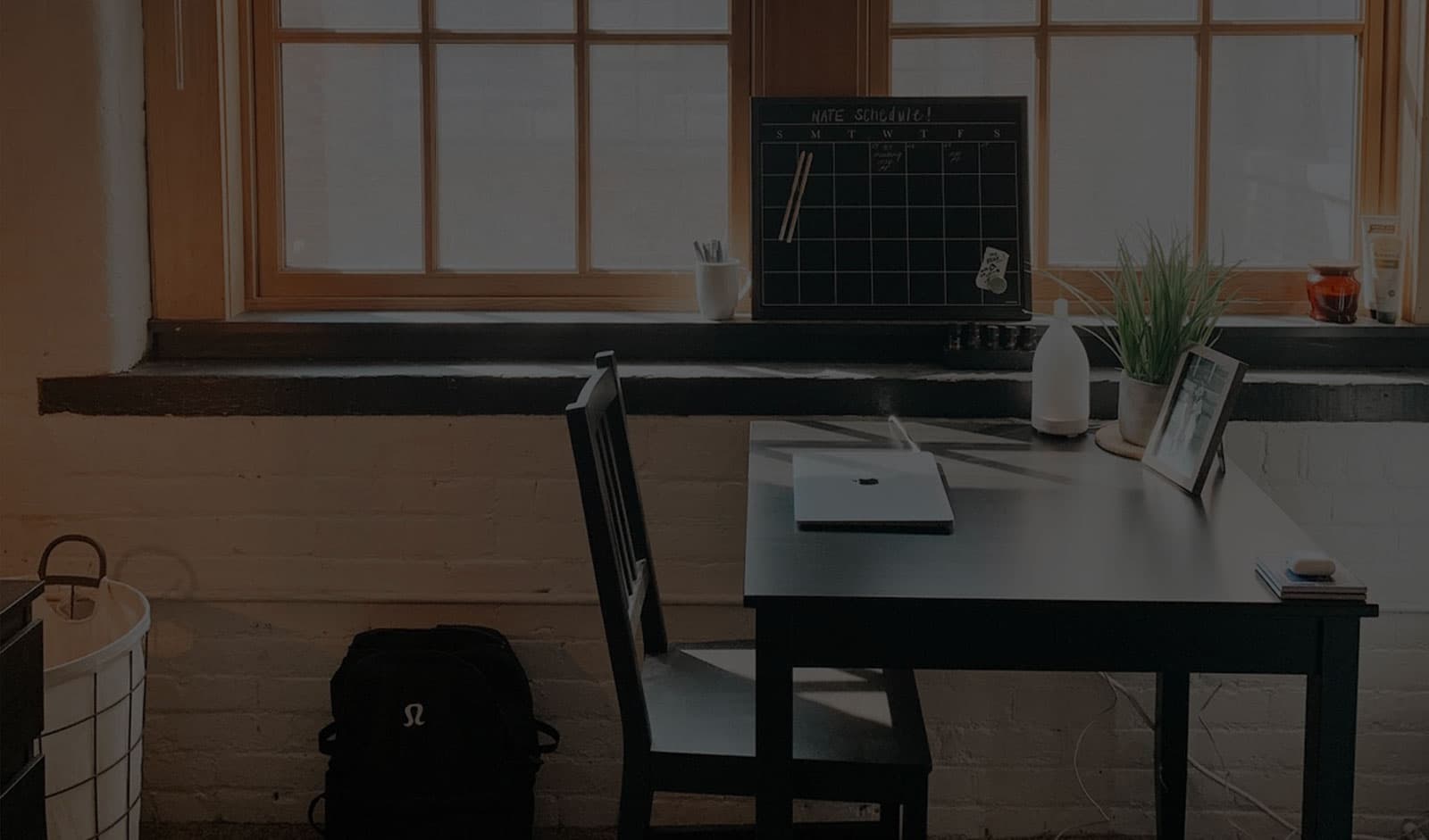A home office with a desk and computer and chair
