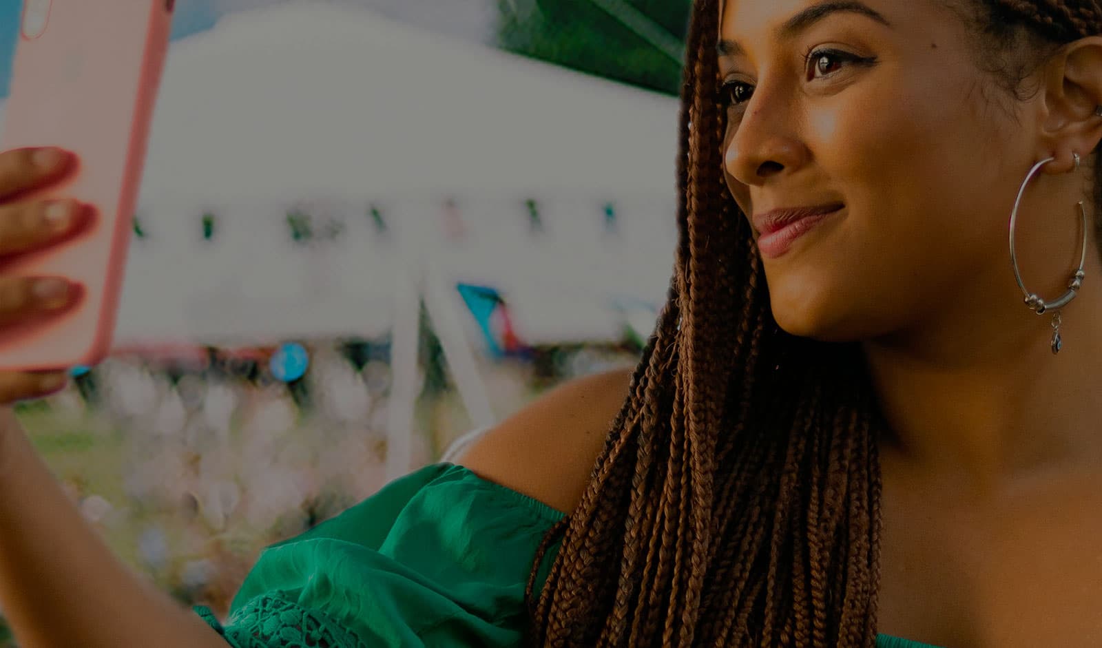 A woman takes a selfie with an iphone