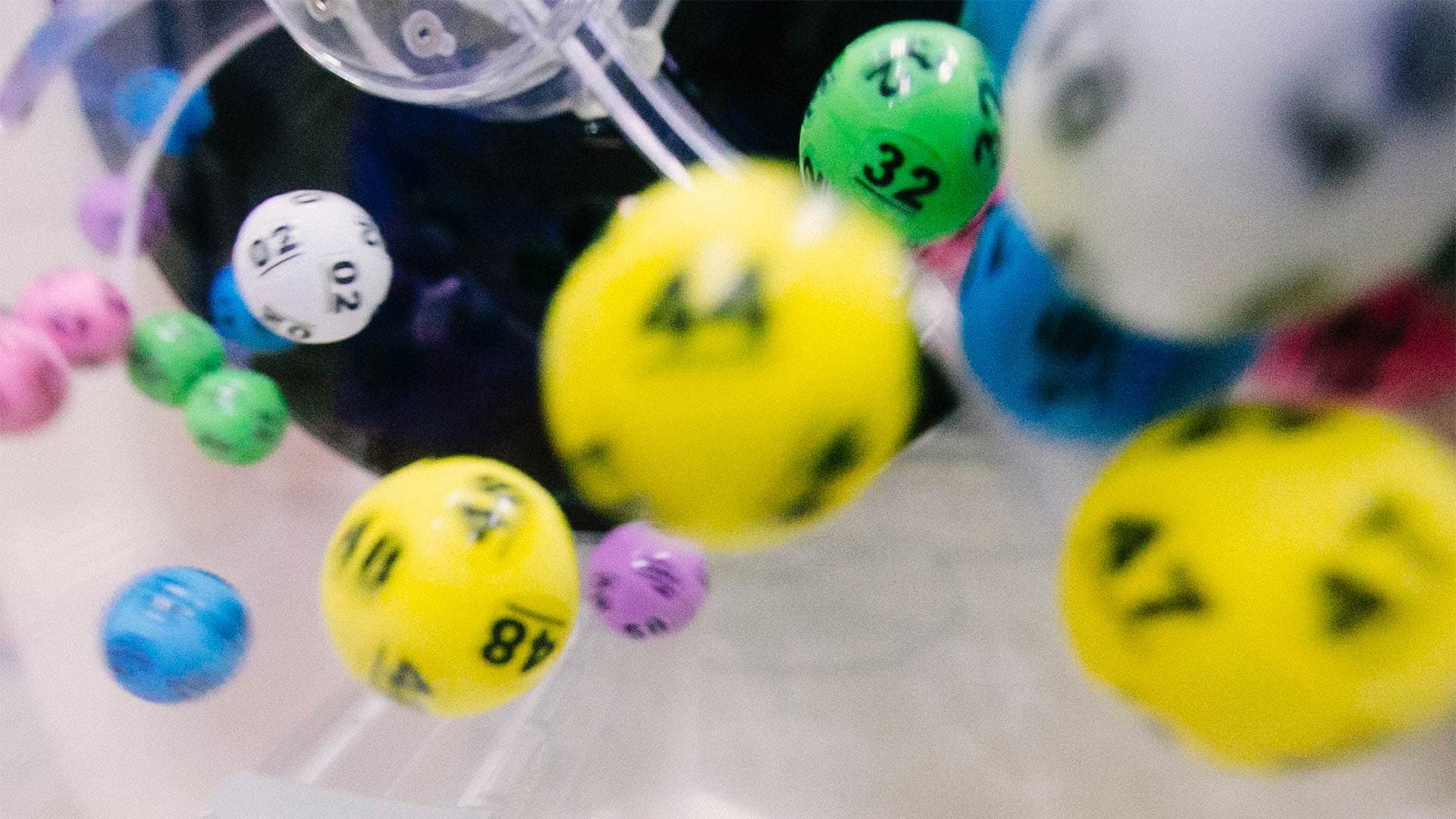 A closeup of lottery balls spinning in a container