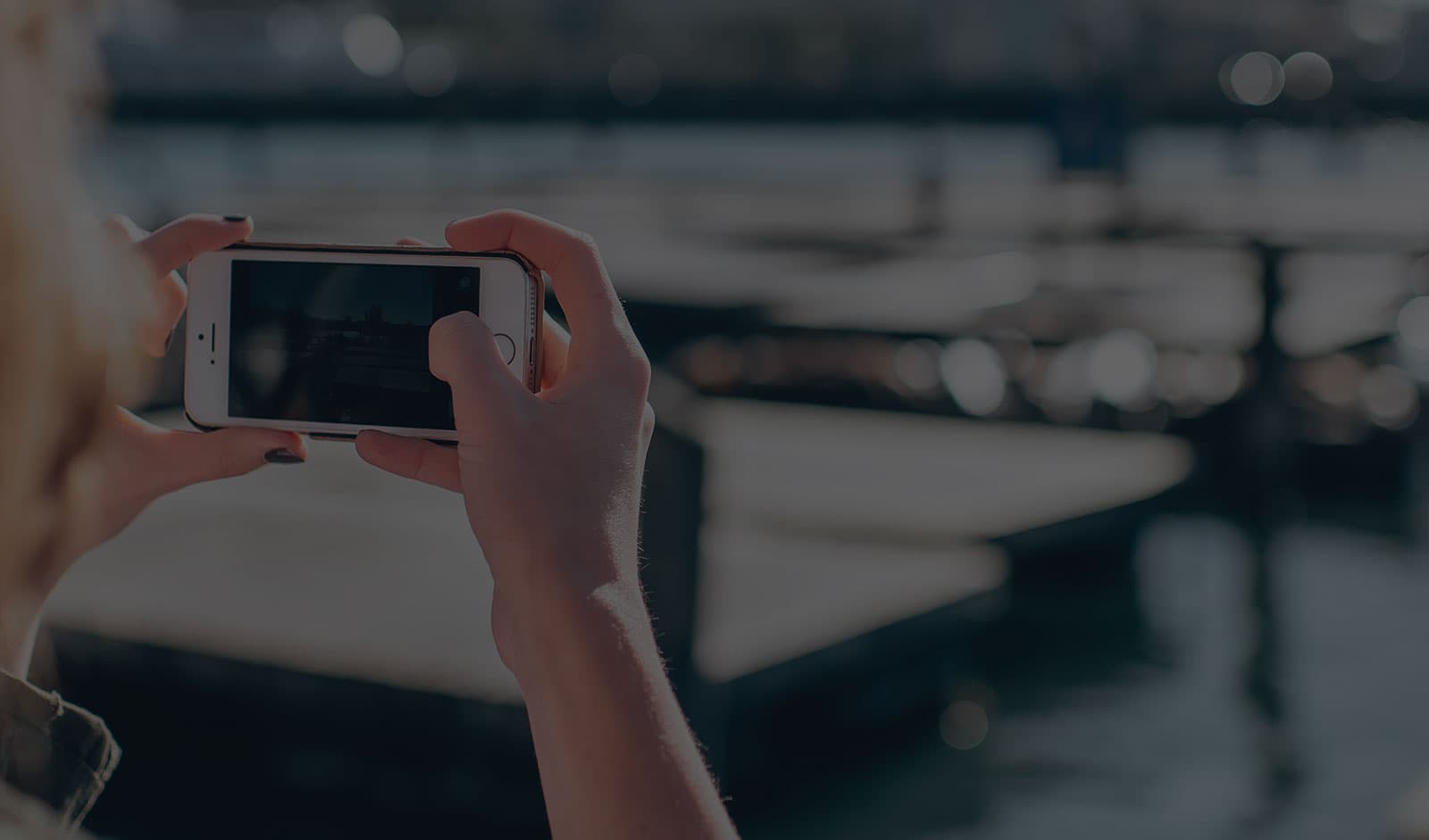 Hands holding a smartphone while taking a picture on vacation