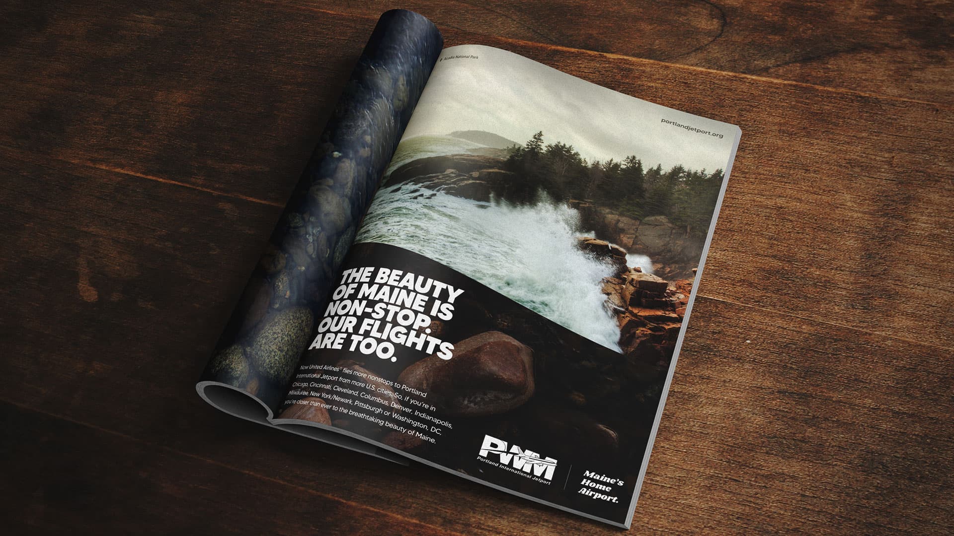 A magazine on a table showing an ad with waves crashing on the shore.