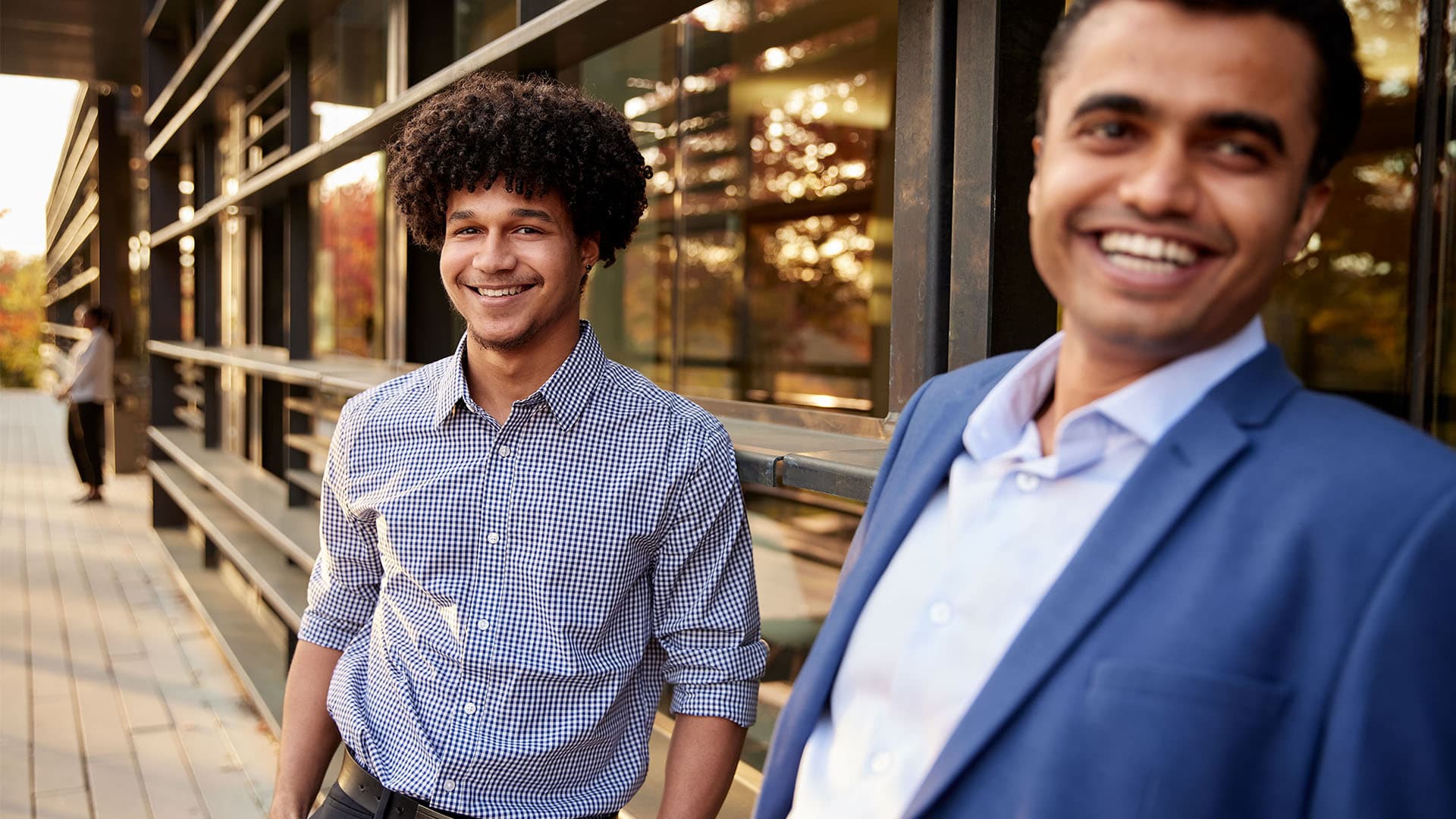 Two people smile at the camera