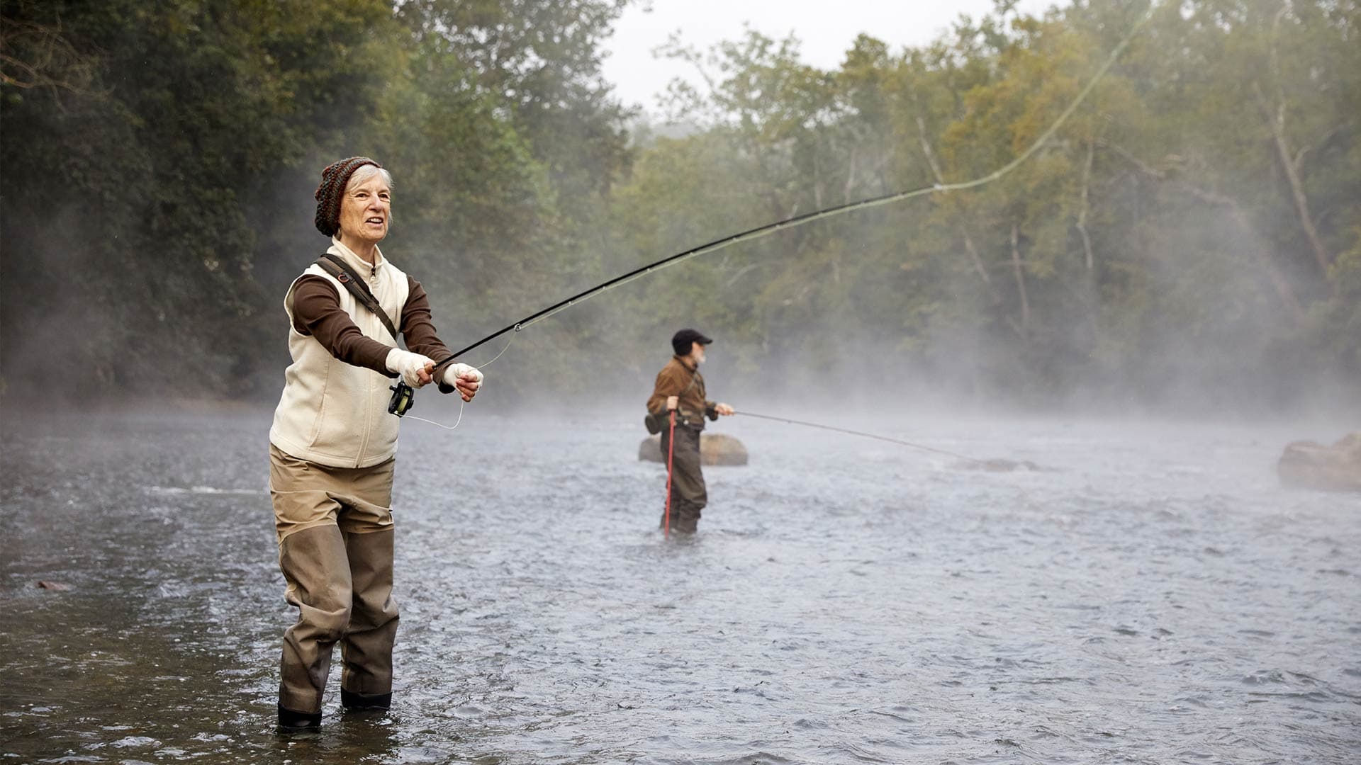 A woman fly fishing.