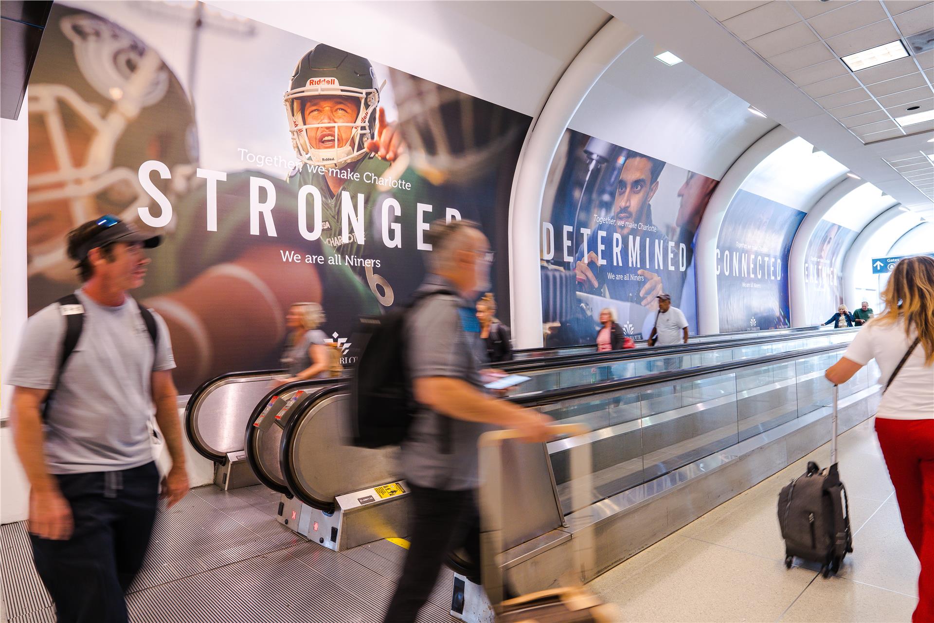 Ad: We are all Niners posters in an airport terminal