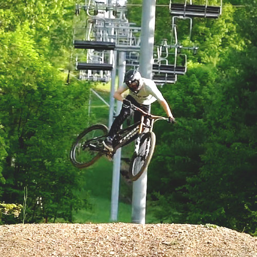 Mountain biker jumping on the slopes